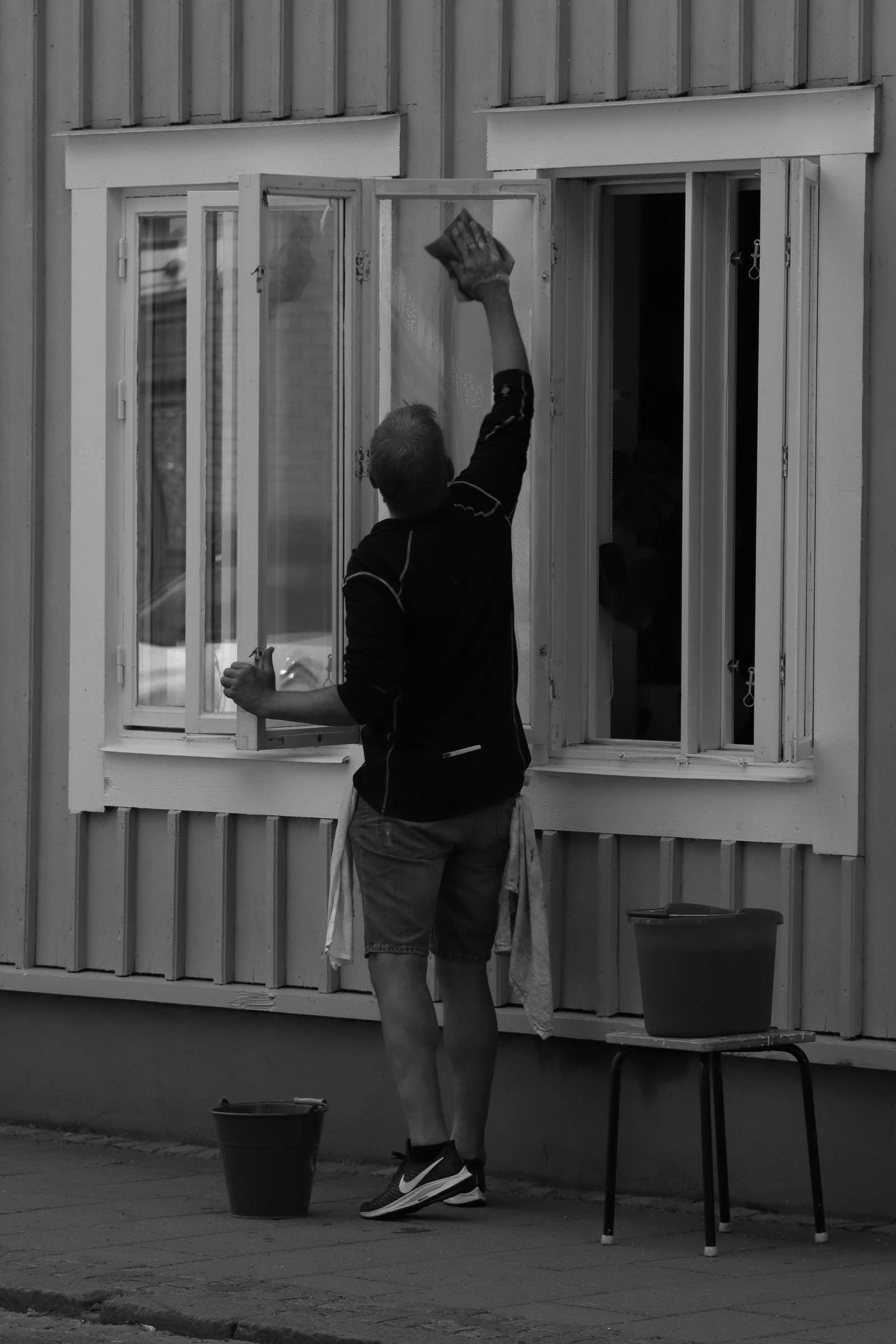 Window cleaner working on a street-level building