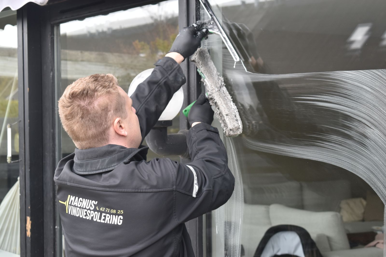 Squeegee drawn across a commercial pane
